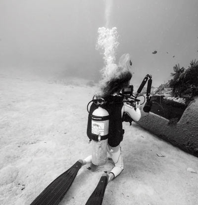 Diver sitting in sand
